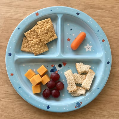 A divided meal plate demonstrating gentle food exposure for autistic children.
