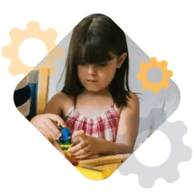 A young child playing with a colorful toy