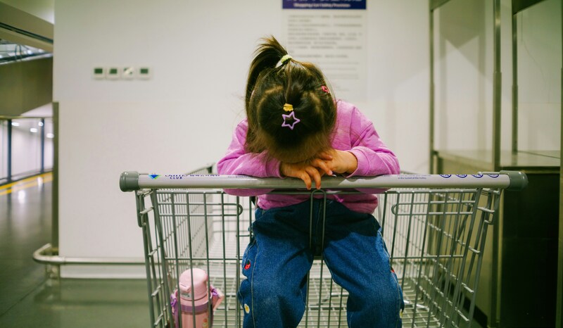 child taking emotional regulation timeout in shopping cart - hero